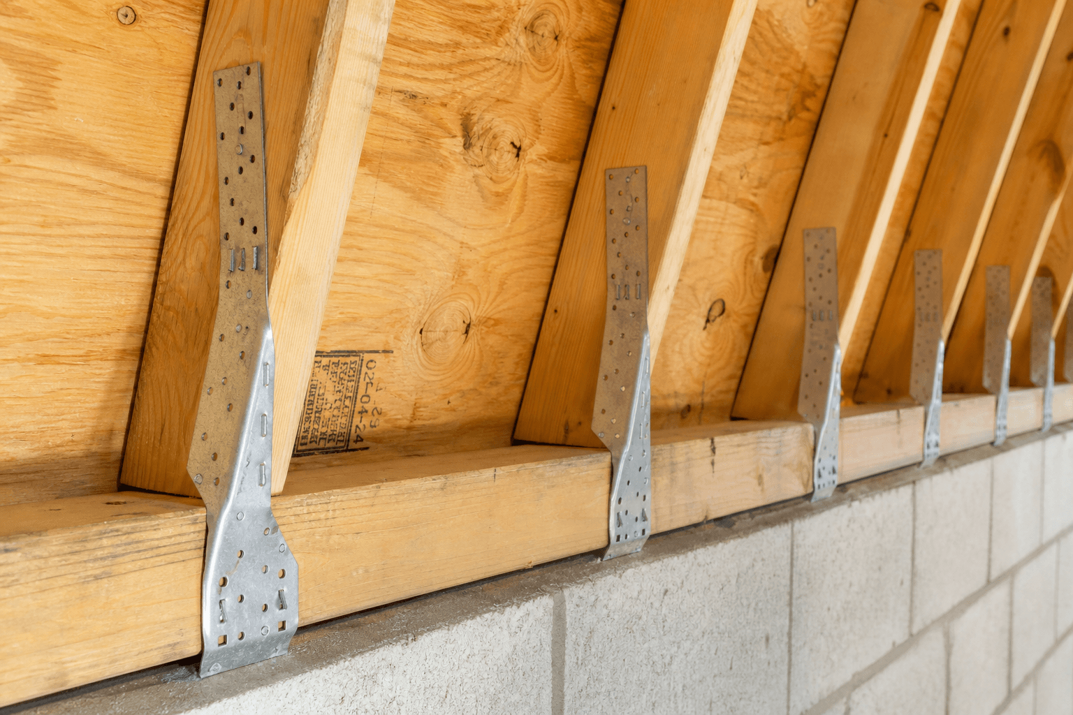 Wind mitigation attic inspection showing roof-to-wall hurricane strap connections